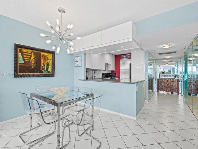 tiled dining room with a notable chandelier