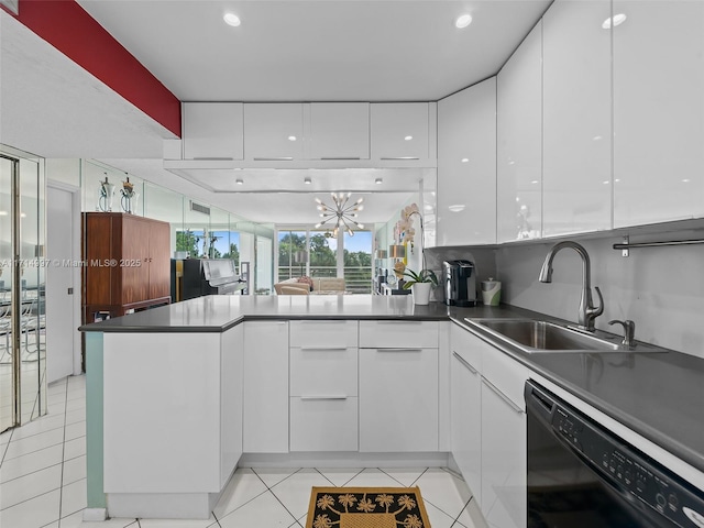 kitchen featuring kitchen peninsula, dishwasher, and white cabinets