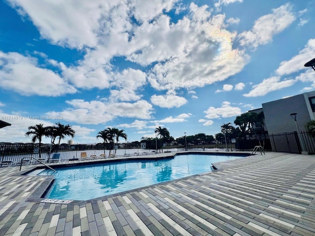 community pool featuring a patio and fence