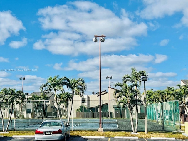 view of sport court featuring fence