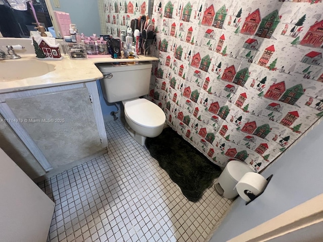 bathroom featuring toilet, vanity, and tile patterned flooring