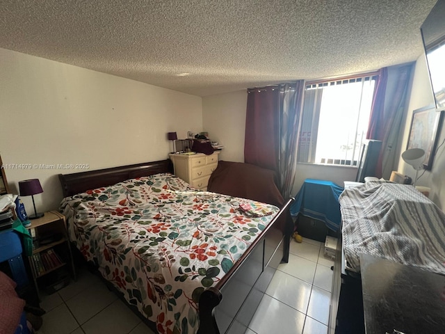 bedroom featuring tile patterned floors and a textured ceiling