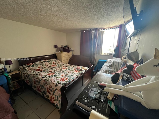 bedroom featuring tile patterned flooring and a textured ceiling