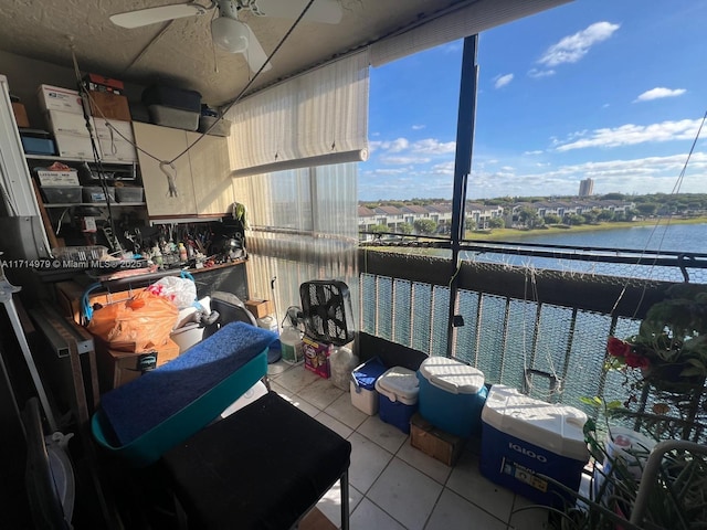 interior space featuring a ceiling fan and a water view