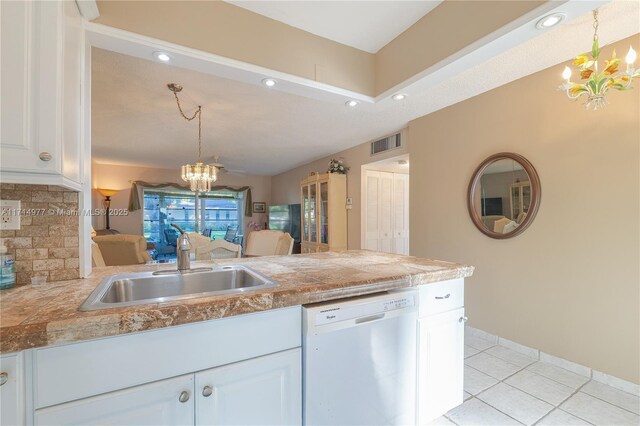 kitchen featuring backsplash, white cabinets, dishwasher, a chandelier, and hanging light fixtures