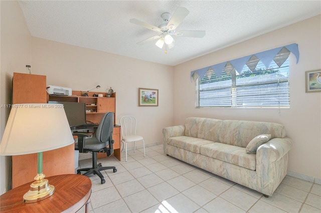 tiled office space featuring a textured ceiling and ceiling fan