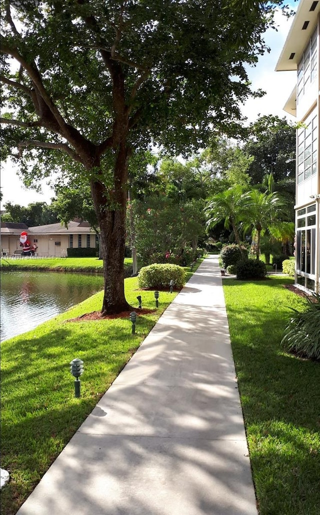 surrounding community featuring a yard and a water view