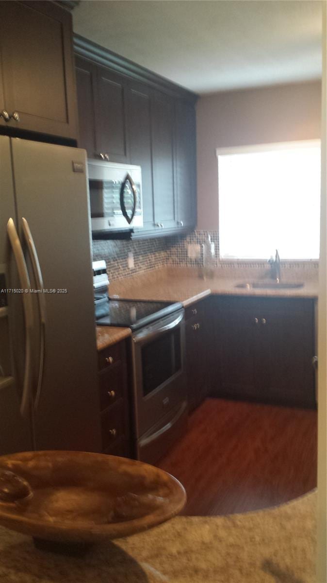 kitchen featuring dark hardwood / wood-style floors, sink, and stainless steel appliances