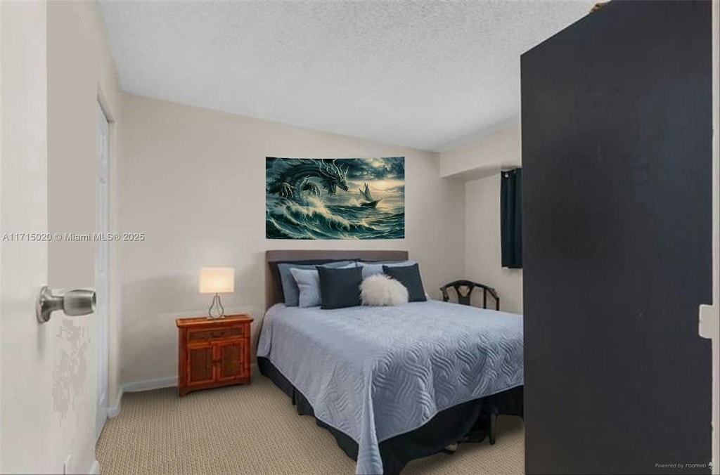 carpeted bedroom with a textured ceiling