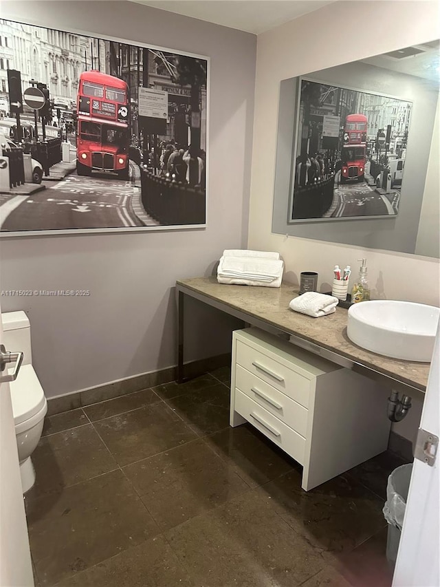 bathroom featuring vanity and toilet