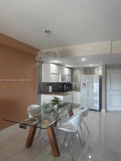 1250 S Miami Ave Unit 2013, Miami, FL 33130 - dining room with light marble finish flooring