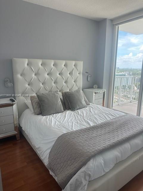 1250 S Miami Ave Unit 2013, Miami, FL 33130 - bedroom featuring floor to ceiling windows, wood finished floors, access to exterior, and a textured ceiling