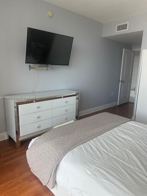 1250 S Miami Ave Unit 2013, Miami, FL 33130 - bedroom featuring baseboards and wood finished floors