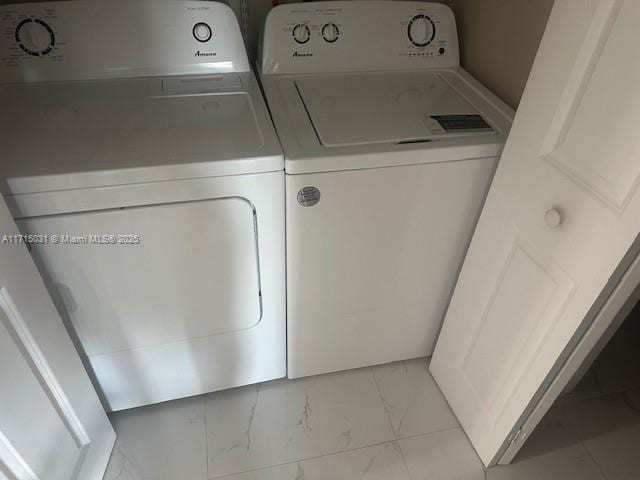 1250 S Miami Ave Unit 2013, Miami, FL 33130 - washroom with separate washer and dryer and light marble finish floors