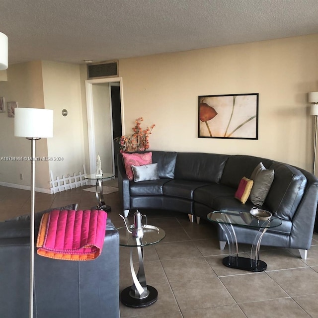 living room featuring tile patterned flooring and a textured ceiling