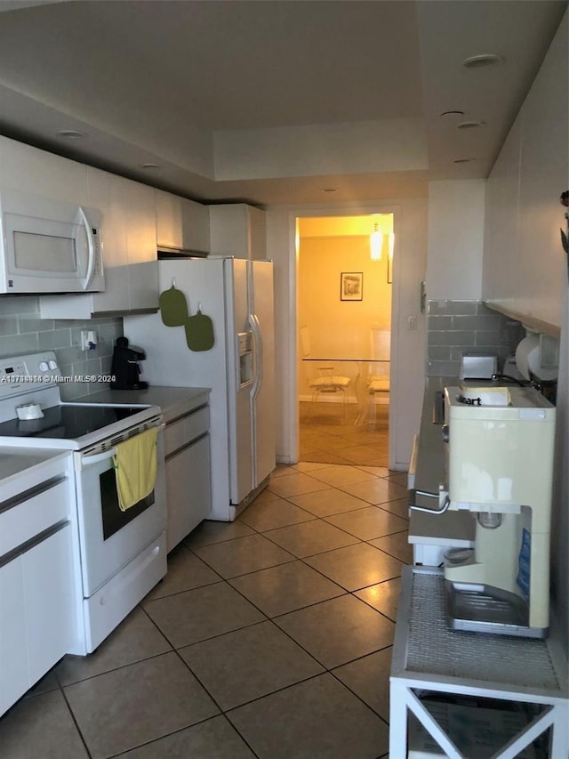 2000 Towerside Ter Unit 905, Miami, FL 33138 - kitchen featuring white appliances, white cabinetry, backsplash, and tile patterned floors