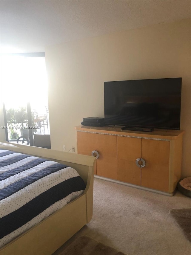 bedroom featuring light carpet