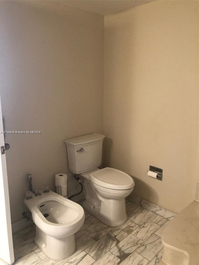 bathroom with a bidet and toilet