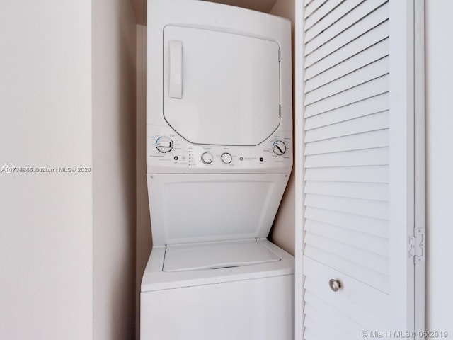 laundry room with stacked washer and dryer