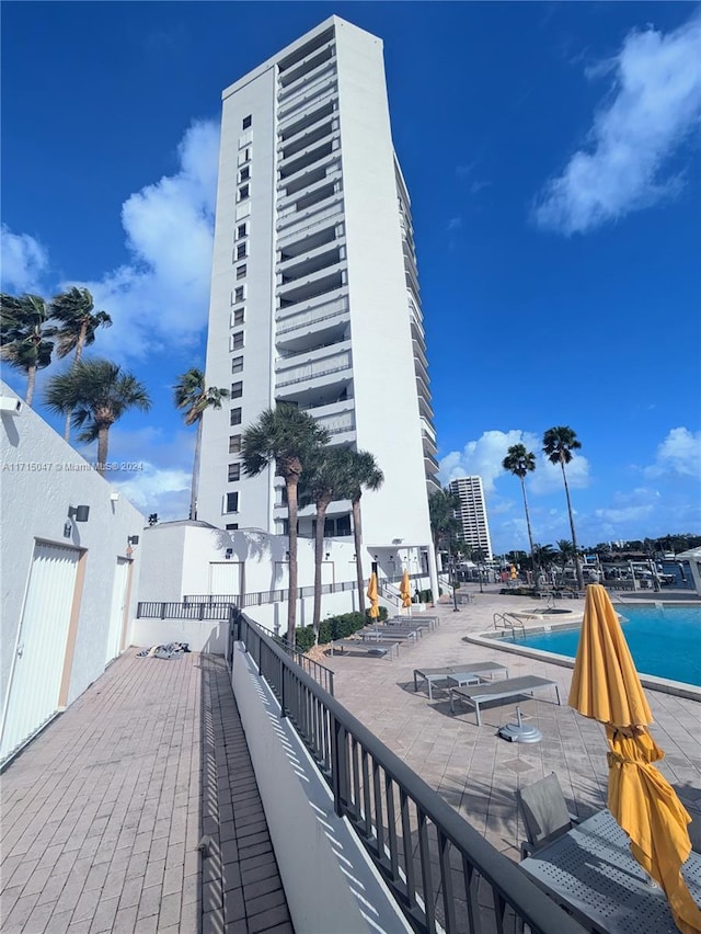 view of property featuring a water view and a community pool