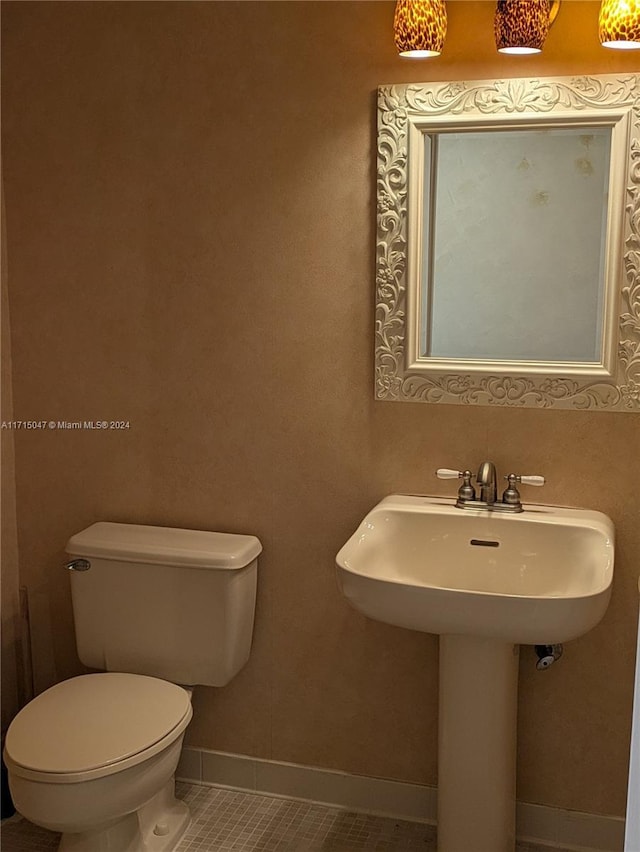 bathroom with tile patterned flooring, toilet, and sink