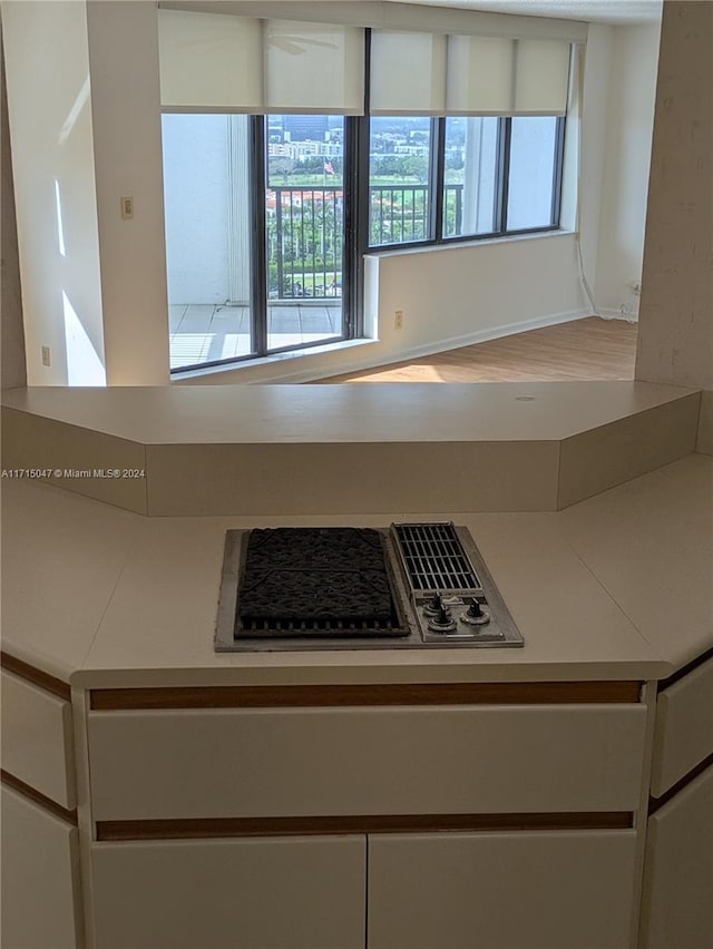 kitchen featuring white cabinets and stainless steel gas cooktop