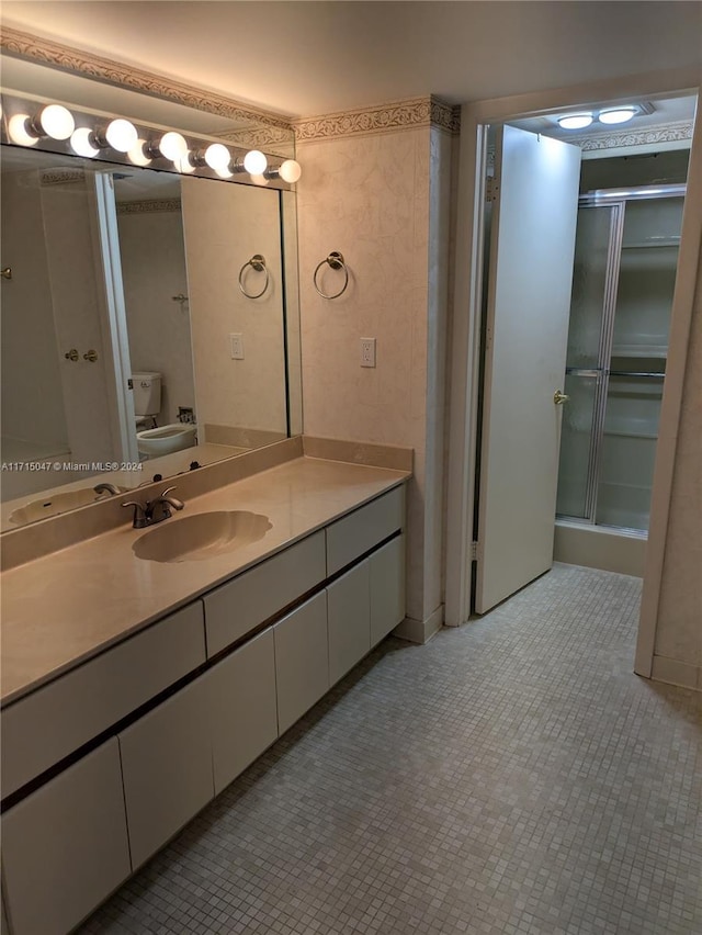 bathroom with toilet, vanity, tile patterned floors, and an enclosed shower