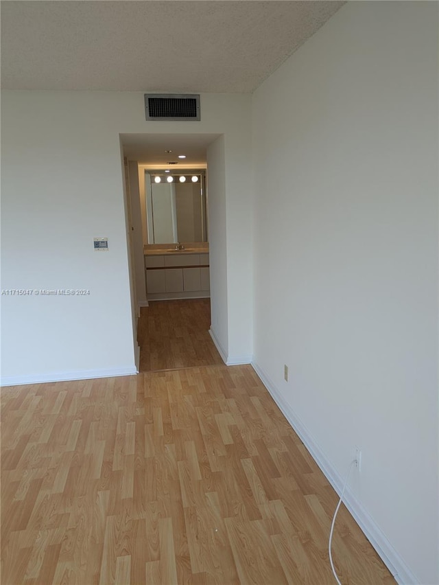 corridor with light hardwood / wood-style floors