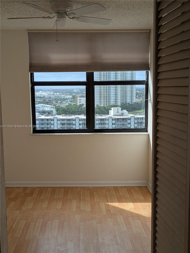 unfurnished room featuring ceiling fan and light wood-type flooring