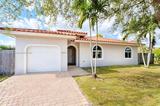 mediterranean / spanish home with a garage and a front yard