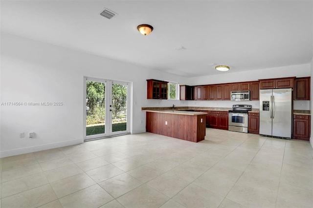 kitchen featuring kitchen peninsula, stainless steel appliances, french doors, and light tile patterned flooring