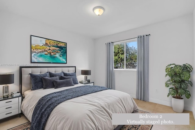 bedroom with light tile patterned floors