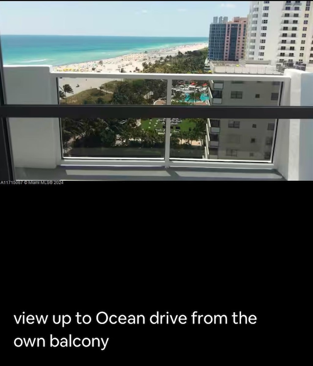 balcony with a water view and a beach view