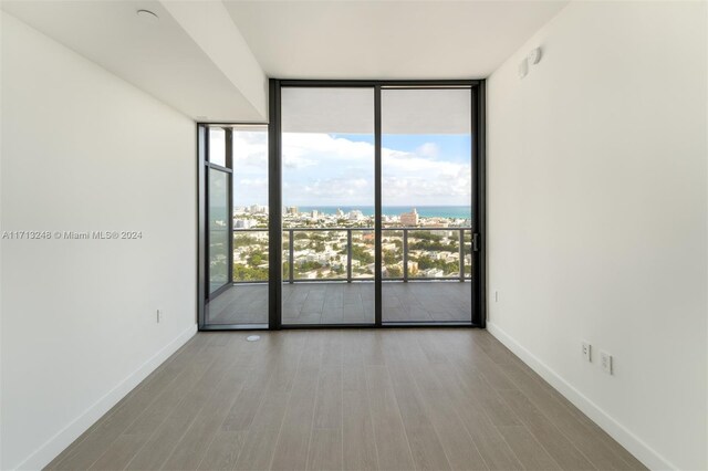 500 Alton Rd Unit 2207, Miami Beach, FL 33139 - spare room with expansive windows and wood finished floors