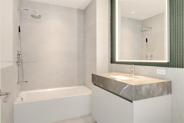 bathroom featuring vanity and tiled shower / bath