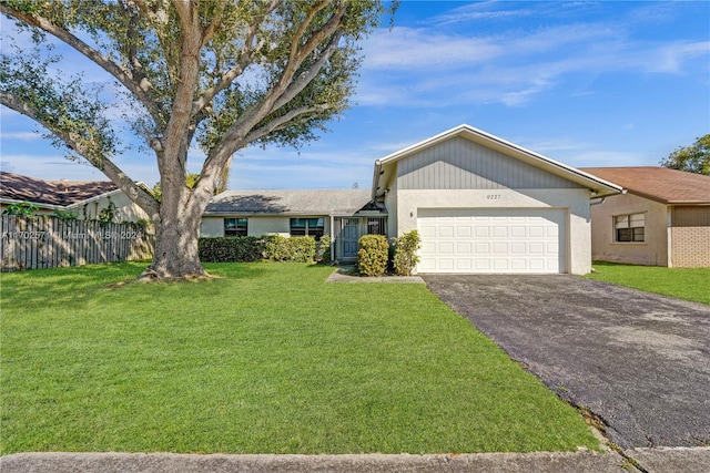 single story home with a garage and a front lawn