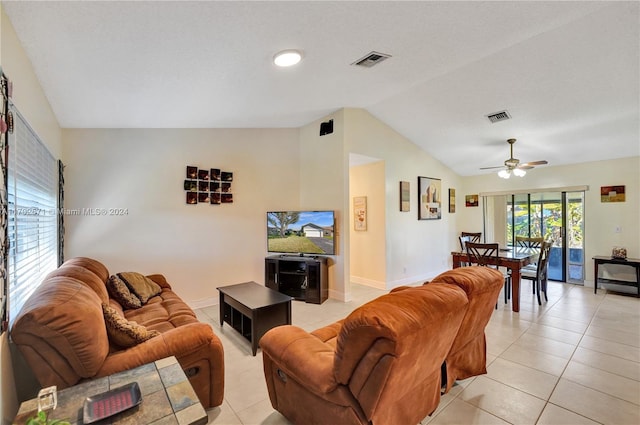 tiled living room with ceiling fan and lofted ceiling