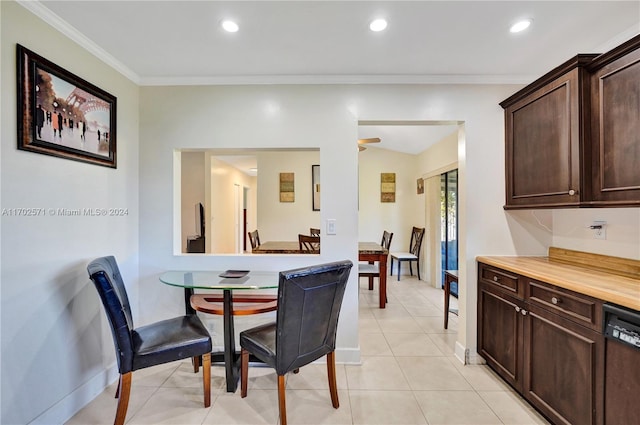 tiled dining area featuring vaulted ceiling, ceiling fan, and ornamental molding