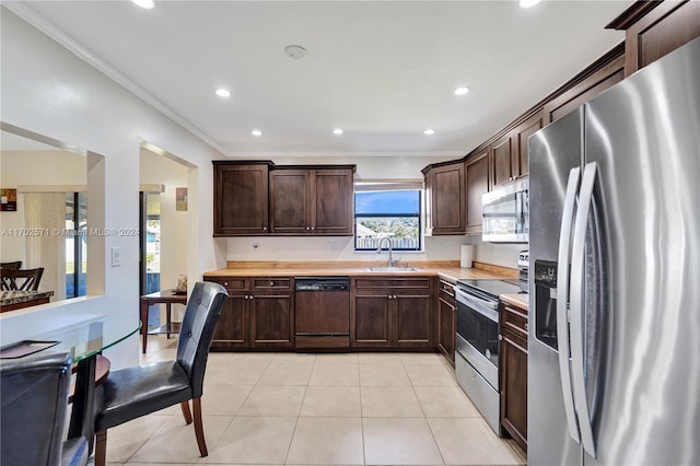 kitchen featuring wood counters, sink, dark brown cabinets, and appliances with stainless steel finishes