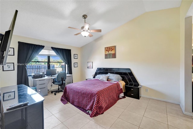 tiled bedroom with a textured ceiling, ceiling fan, and lofted ceiling