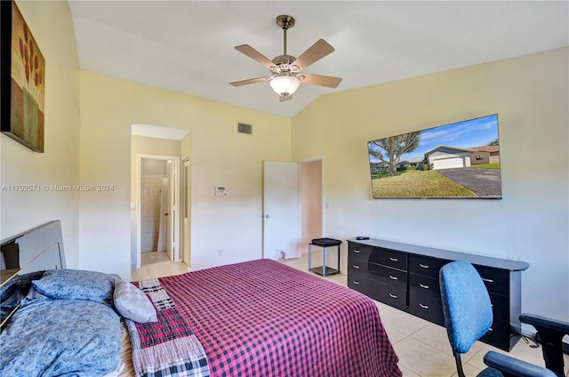 bedroom featuring ceiling fan, light tile patterned flooring, lofted ceiling, and connected bathroom