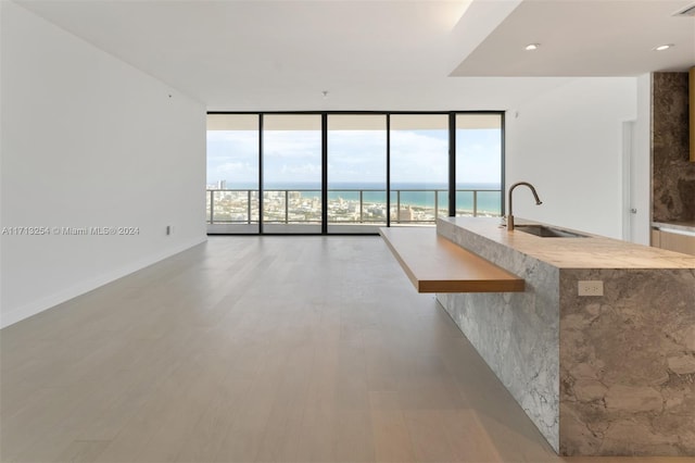 500 Alton Rd Unit 3905, Miami Beach, FL 33139 - unfurnished living room with floor to ceiling windows, light wood-type flooring, and a water view
