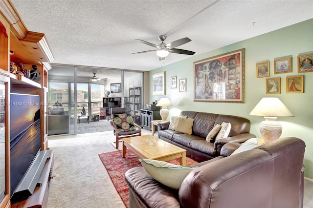 living room featuring ceiling fan, light colored carpet, and a textured ceiling