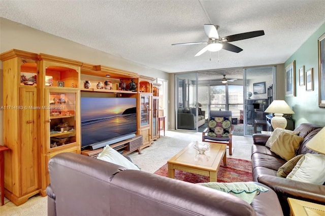 living room with light carpet, a textured ceiling, and ceiling fan