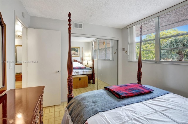 bedroom featuring a textured ceiling and a closet