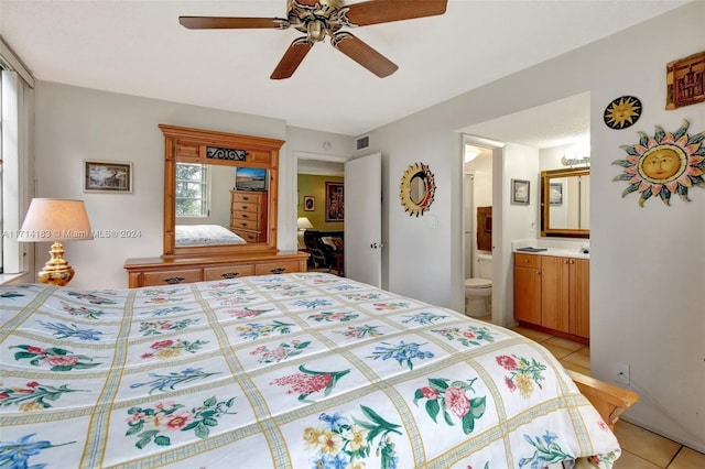 bedroom featuring connected bathroom, ceiling fan, and light tile patterned flooring