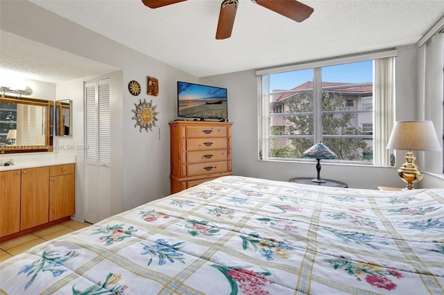 bedroom featuring multiple windows, a textured ceiling, a closet, and ceiling fan