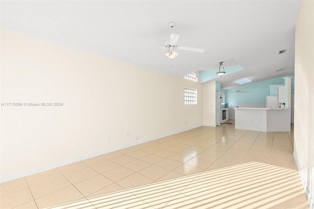 unfurnished room featuring ceiling fan, lofted ceiling, and light tile patterned flooring