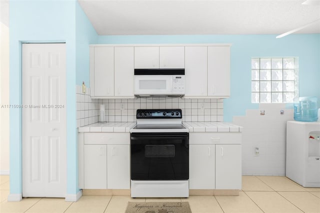 kitchen featuring white cabinetry, light tile patterned flooring, white appliances, and tasteful backsplash