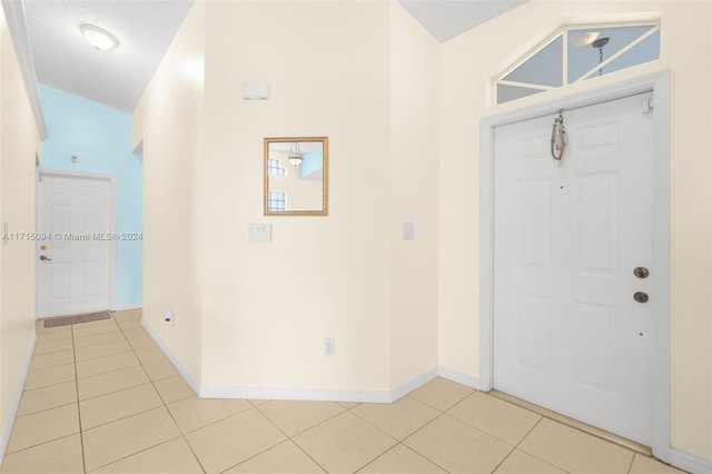 tiled entryway featuring a textured ceiling